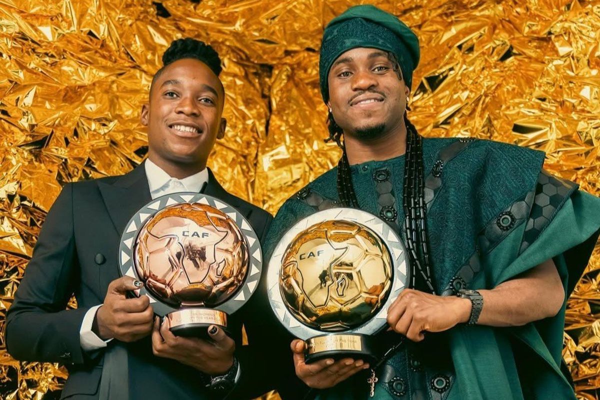 Banda and Lookman smile at the camera while holding awards won at CAF 2024 ceremony.