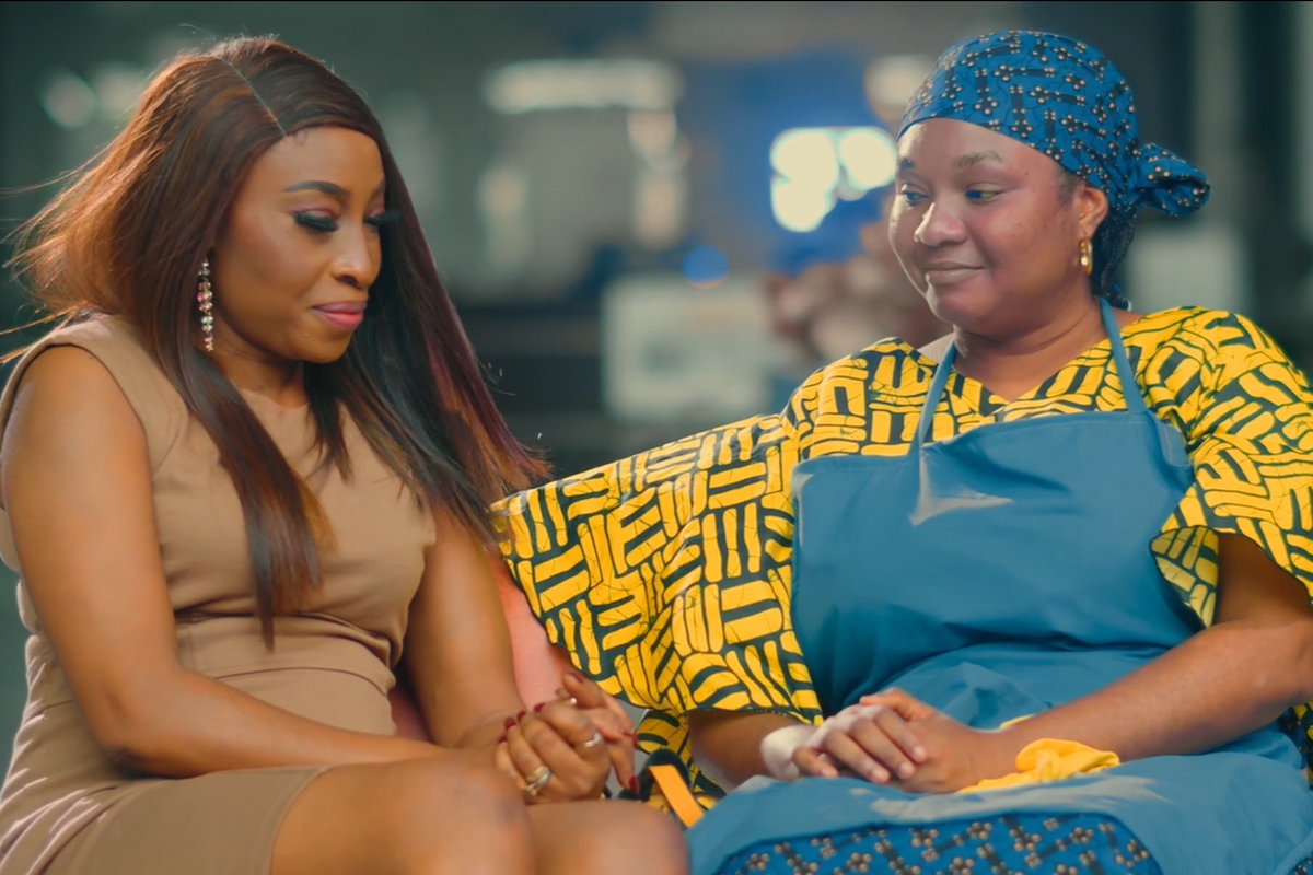 Two women sit side by side mid-conversation.